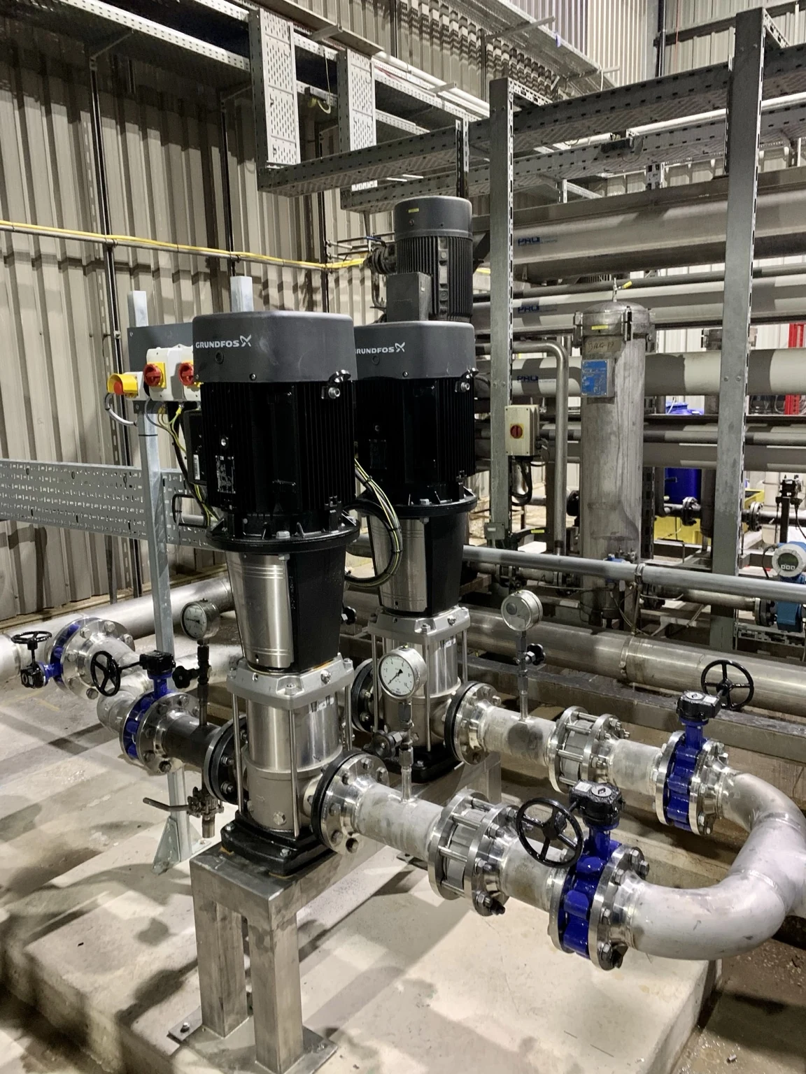 Vertical pump assemblies with stainless pipework and valves